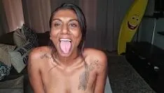 Play Desi sits on the couch drooling as she sticks out and wiggles her tongue around